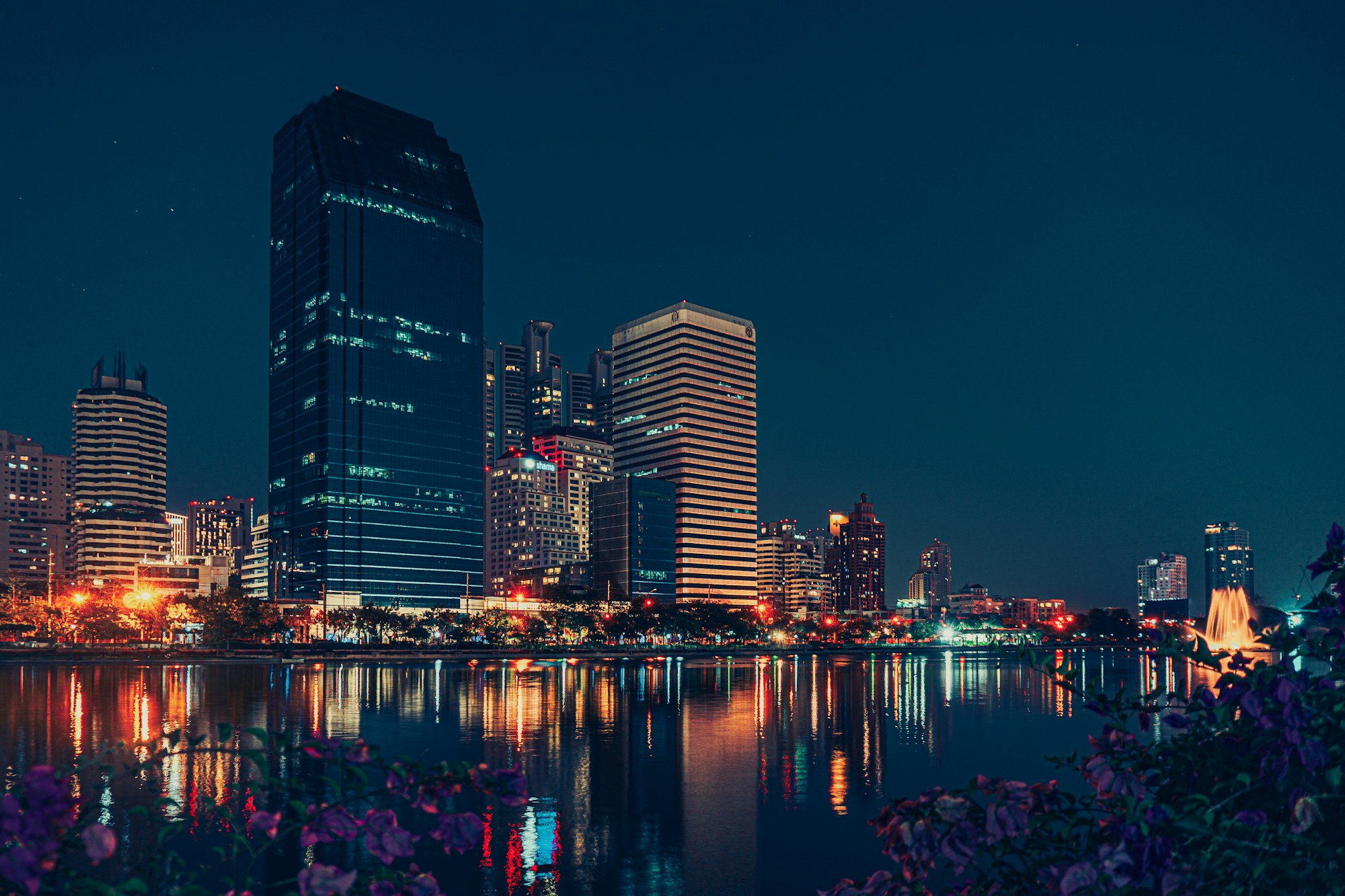 Bangkok skyline reflected in a lake at night